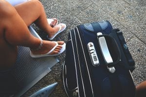 international schools Search Associates ANZ summer traveller with suitcase in an airport 
