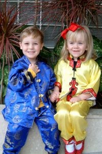 Succeeding in your new school Search Associates ANZ two children smiling as they model traditional Chinese clothing 