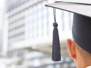 qualifications required international schools Search Associates ANZ image of a man wearing a mortarboard 