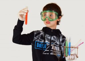 Search Associates ANZ primary school student performing a science experiment 