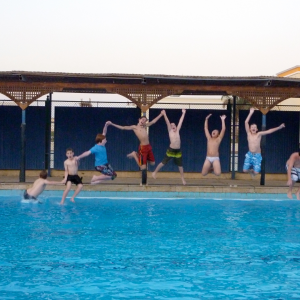should I teach overseas with my family? Search Associates ANZ Students having fun jumping into the school pool